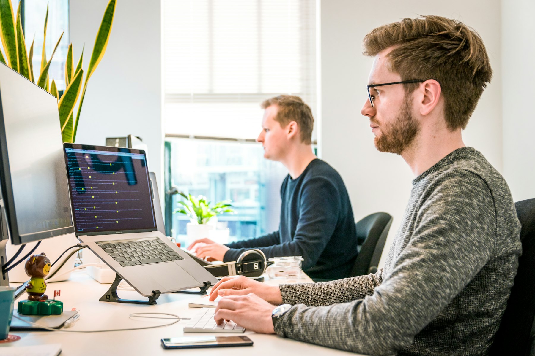 Software engineer reviewing code at a bright modern desk
