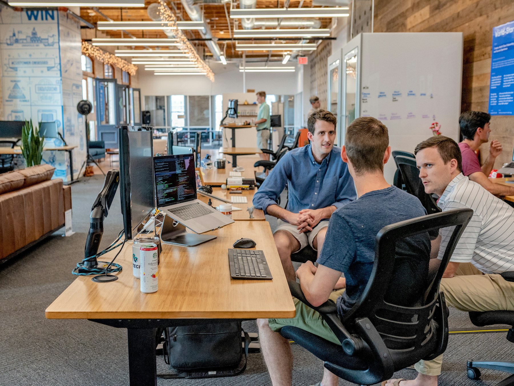 Engineers collaborating around code in a modern office